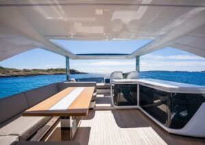 Luxurious 2022 Pearl 62 yacht interior with ocean view, featuring sleek seating and modern design.