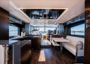 Luxurious interior of 2022 Pearl 62 yacht with modern furnishings and panoramic windows.