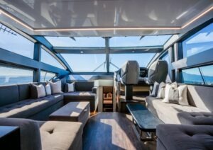 Luxurious interior of 2022 Pearl 62 yacht with panoramic windows and plush seating.