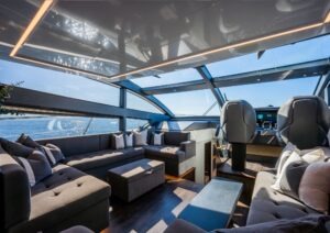 Luxurious interior of 2022 Pearl 62 yacht with panoramic windows and plush seating.