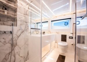 Luxurious 2022 Pearl 62 yacht bathroom with marble decor and modern fixtures.