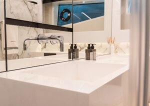 Modern bathroom sink with chrome faucet in 2022 Pearl 62 yacht.