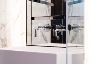 Modern bathroom faucet with marble backdrop, Pearl 62 model, 2022 design.