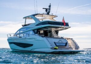 Luxurious 2022 Pearl 62 yacht cruising on open water under clear skies.