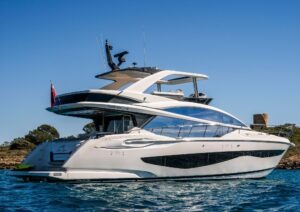 2022 Pearl 62 yacht cruising on clear blue waters under a sunny sky.