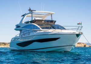 Luxurious 2022 Pearl 62 yacht on clear blue water, showcasing sleek design and elegance.
