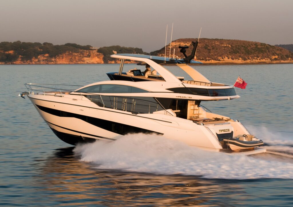 Luxurious 2023 Pearl 62 yacht cruising on serene waters at sunset.