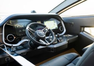 Modern helm of 2023 Pearl 62 yacht with advanced navigation displays and controls.