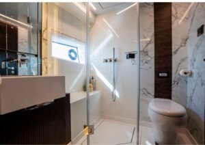 Luxurious bathroom in 2023 Pearl 62 yacht with modern fixtures and marble accents.