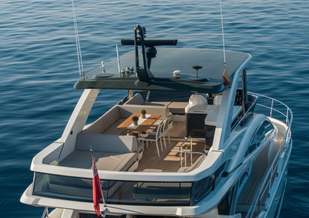 Luxurious 2023 Pearl 62 yacht with spacious deck and elegant seating on calm waters.