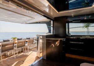 Luxurious Pearl 62 yacht interior with ocean view, featuring modern dining and kitchen area, 2023 model.