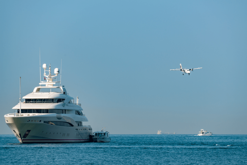 superyacht out at the sea with chasing boat