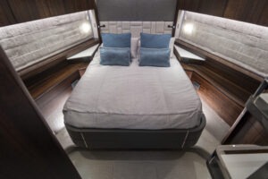 Luxurious bedroom interior of 2021 Sunseeker Manhattan 68 yacht with modern design.
