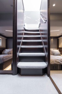 Interior staircase of 2021 Sunseeker Manhattan 68 yacht, leading to luxurious bedrooms.