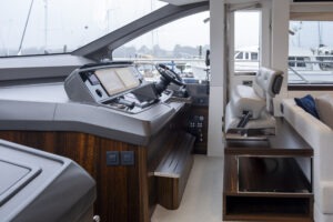 Interior helm of 2021 Sunseeker Manhattan 68 yacht, featuring modern controls and seating.