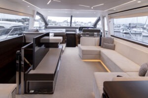 Luxurious interior of 2021 Sunseeker Manhattan 68 yacht with modern seating and large windows.