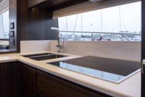 Luxurious kitchen interior of 2021 Sunseeker Manhattan 68 yacht with modern fixtures.