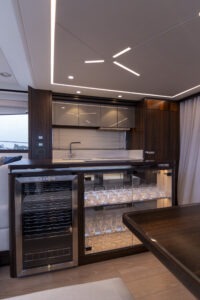 Luxurious interior of 2021 Sunseeker Manhattan 68 yacht with modern bar area.
