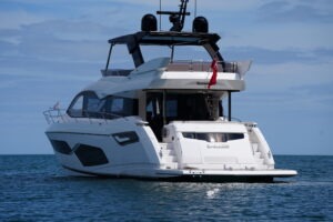 2021 Sunseeker Manhattan 68 yacht on calm ocean waters.