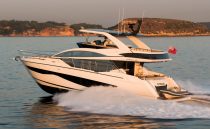 Luxurious 2023 Pearl 62 yacht cruising on serene waters at sunset.