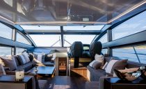 Luxurious interior of 2023 Pearl 62 yacht with modern seating and panoramic windows.