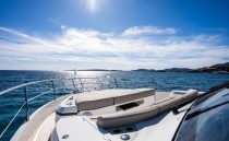 Luxurious Pearl 62 yacht deck, 2022 model, cruising on a sunny ocean.