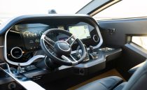 Modern helm of 2023 Pearl 62 yacht with advanced navigation displays and controls.