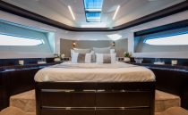 Luxurious bedroom interior of 2023 Pearl 62 yacht with modern design and elegant decor.