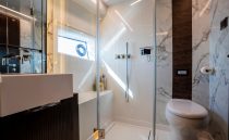 Luxurious bathroom in 2023 Pearl 62 yacht with modern fixtures and marble accents.