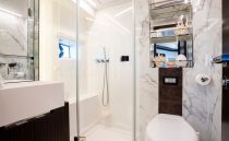 Luxurious 2023 Pearl 62 yacht bathroom with marble accents and modern fixtures.