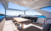 Luxurious 2022 Pearl 62 yacht interior with seating and ocean view.