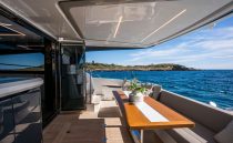 Luxurious 2022 Pearl 62 yacht deck with elegant seating and ocean view.