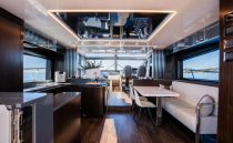 Luxurious interior of 2022 Pearl 62 yacht with modern furnishings and panoramic windows.