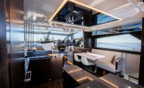 Luxurious interior of 2022 Pearl 62 yacht with modern dining and seating area.