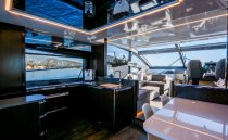 Luxurious interior of 2022 Pearl 62 yacht with modern kitchen and seating area.