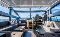 Luxurious interior of 2022 Pearl 62 yacht with panoramic windows and plush seating.