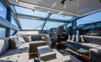 Luxurious interior of 2022 Pearl 62 yacht with modern seating and panoramic windows.