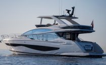 Luxurious 2023 Pearl 62 yacht cruising on calm waters at sunset.