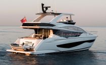 Luxurious 2023 Pearl 62 yacht cruising at sunset on calm waters.