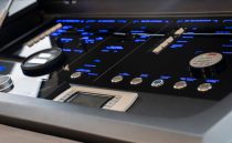 Control panel of a 2022 Pearl 62 yacht with illuminated buttons and displays.