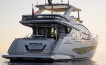 Luxurious 2023 Pearl 62 yacht on calm waters at sunset.