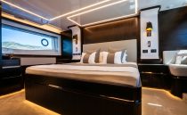 Luxurious 2022 Pearl 62 yacht bedroom with modern design and ambient lighting.