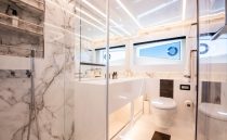 Luxurious 2022 Pearl 62 yacht bathroom with marble decor and modern fixtures.