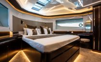 Luxurious bedroom interior of 2022 Pearl 62 yacht with modern design and ambient lighting.