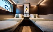 Luxurious twin cabin interior on 2022 Pearl 62 yacht, featuring modern design and ambient lighting.