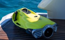 Yellow Pearl 62 sea scooter on yacht deck, 2022 model, near blue ocean water.