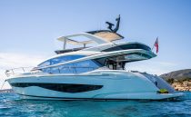 2022 Pearl 62 yacht on blue ocean, sleek design, sunny day.