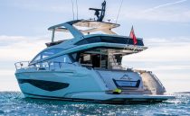 Luxurious 2022 Pearl 62 yacht cruising on open water under clear skies.