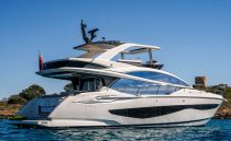 2022 Pearl 62 yacht cruising on clear blue waters under a sunny sky.