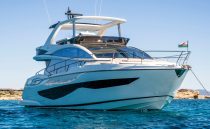 Luxurious 2022 Pearl 62 yacht on clear blue water, showcasing sleek design and elegance.